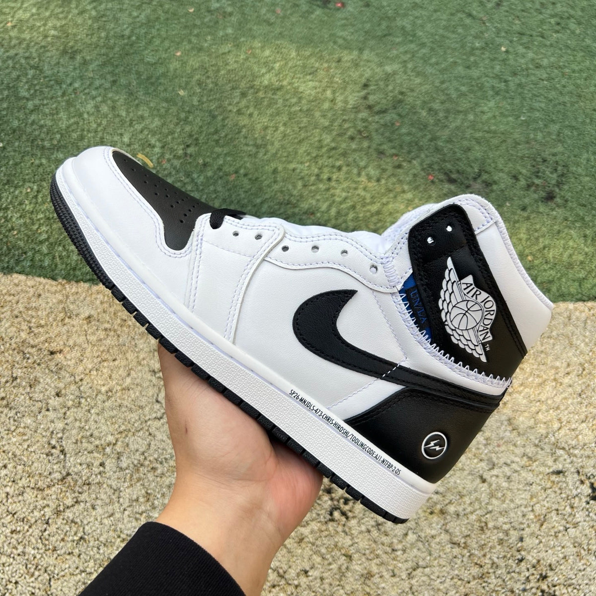 Nike Air Jordan 1 Retro High OG SP Fragment x Union LA sneakers in white and black with Nike swoosh and high-top design.