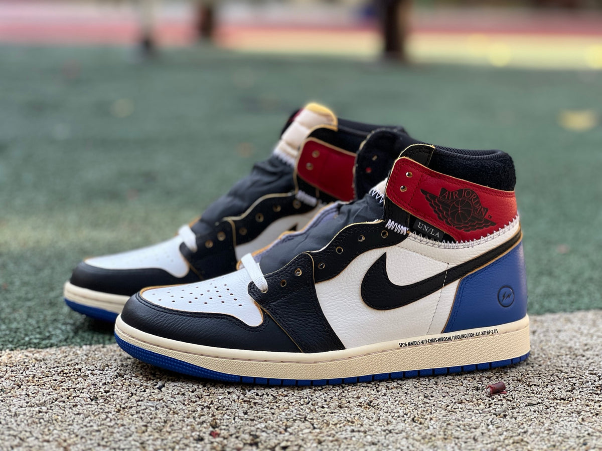 Nike Air Jordan 1 Retro High OG SP Fragment x Union LA sneakers in Varsity Red and Sport Royal, showing the side view with branding.