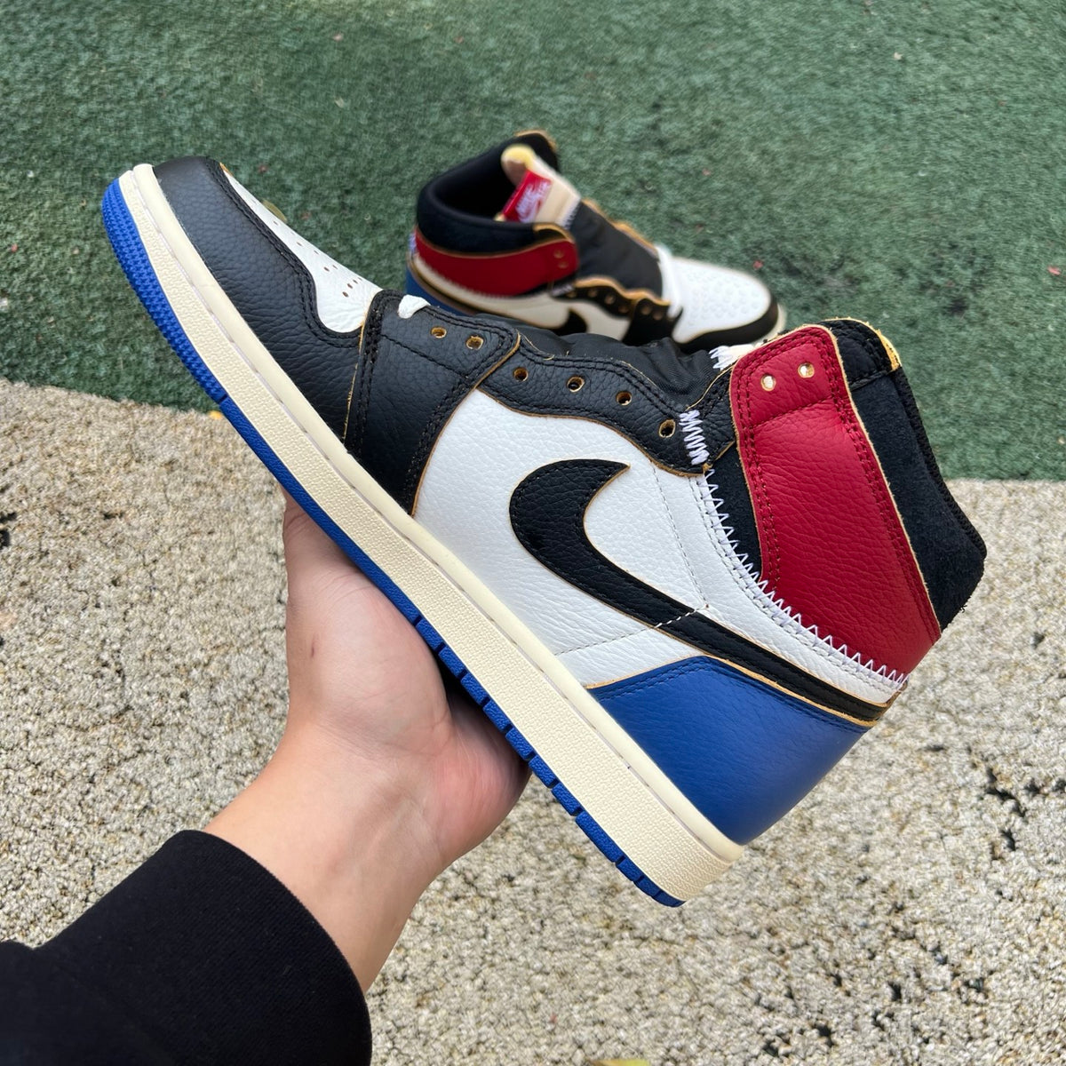 Nike Air Jordan 1 Retro High OG SP Fragment x Union LA Varsity Red and Sport Royal sneakers on display.