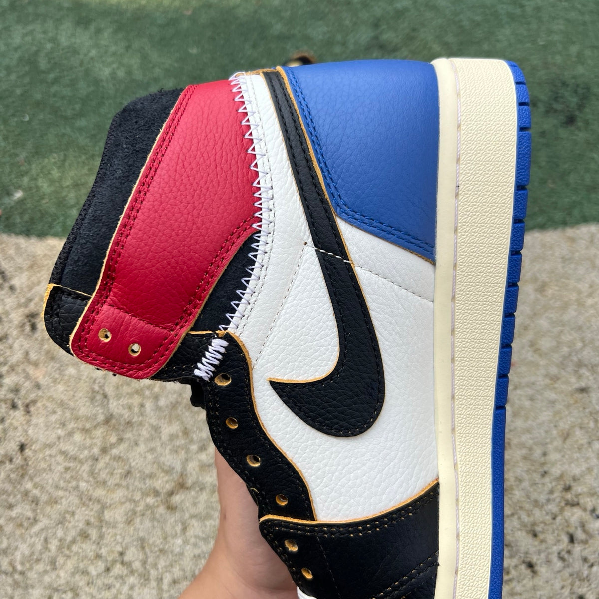 Nike Air Jordan 1 Retro High OG SP Fragment x Union LA Varsity Red and Sport Royal sneakers on display.