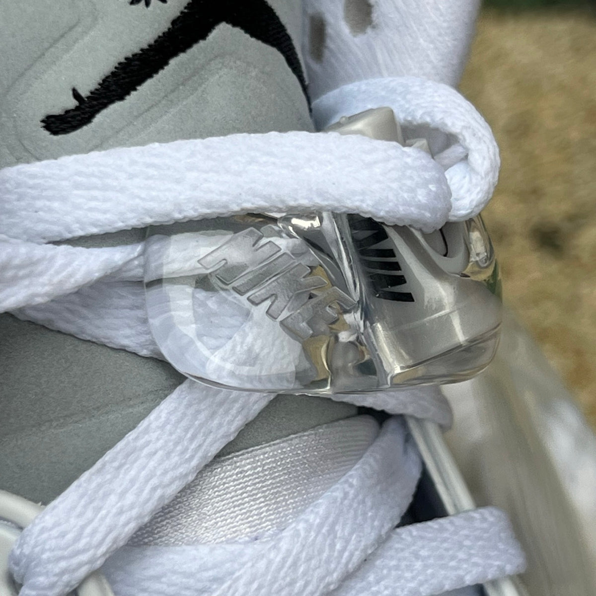 Nike Air Jordan 5 Retro White Metallic sneakers, showcasing the iconic design with metallic accents and classic white leather details.