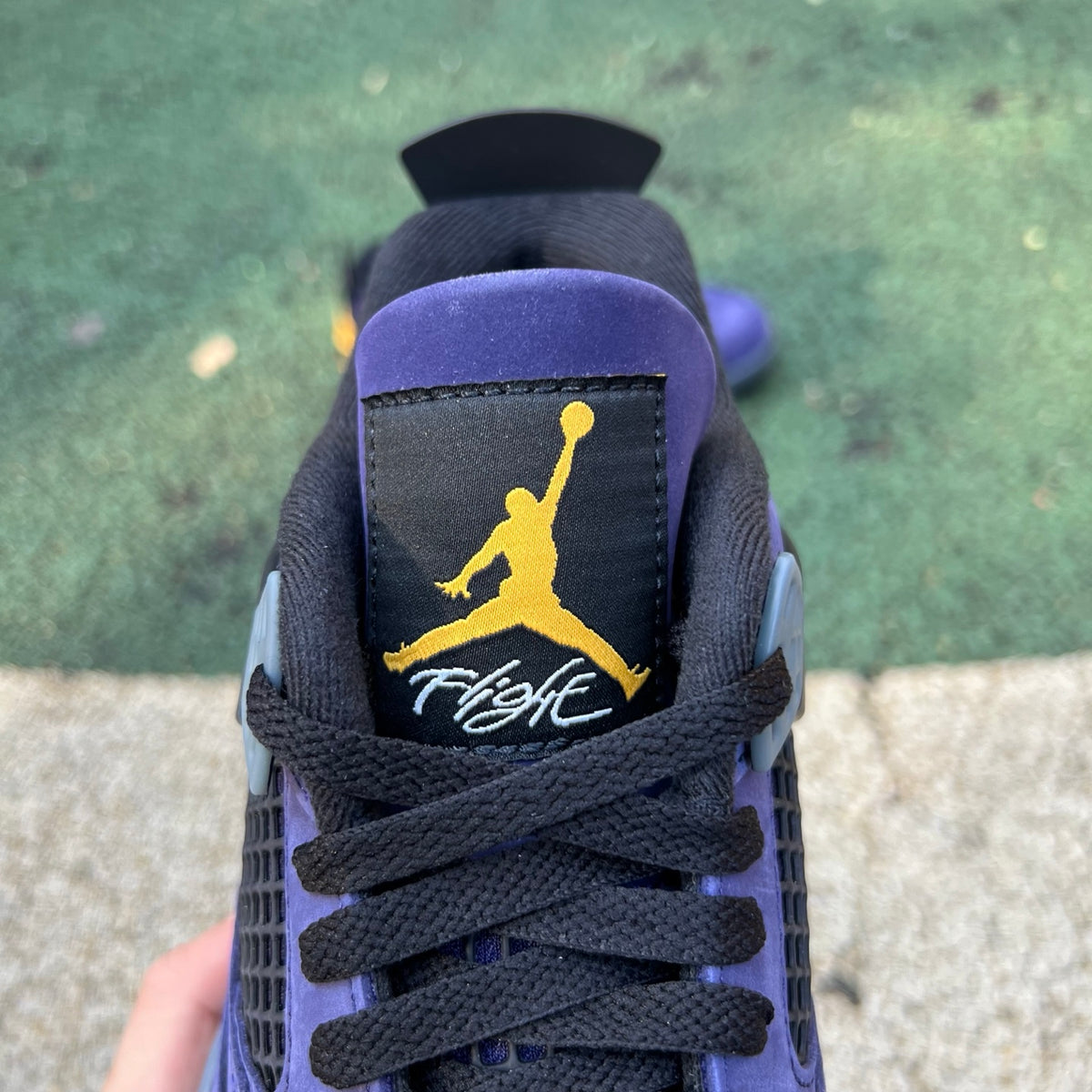 Nike Air Jordan 4 Retro Lakers sneakers in purple and gold with white accents, showcasing the iconic basketball shoe design.