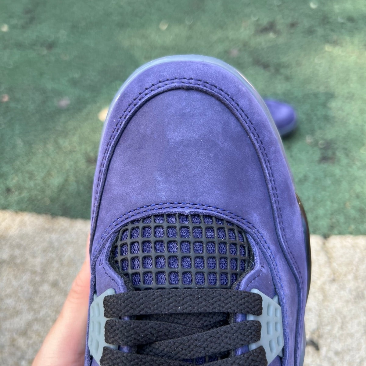 Nike Air Jordan 4 Retro Lakers sneakers in purple and gold with white accents, showcasing the iconic basketball shoe design.