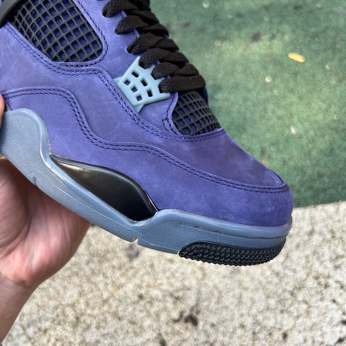 Nike Air Jordan 4 Retro Lakers sneakers in purple and yellow, featuring classic design with Nike and Jordan branding.