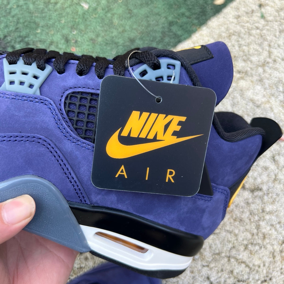 Nike Air Jordan 4 Retro Lakers sneakers in purple and yellow with white accents, featuring a classic basketball shoe design.