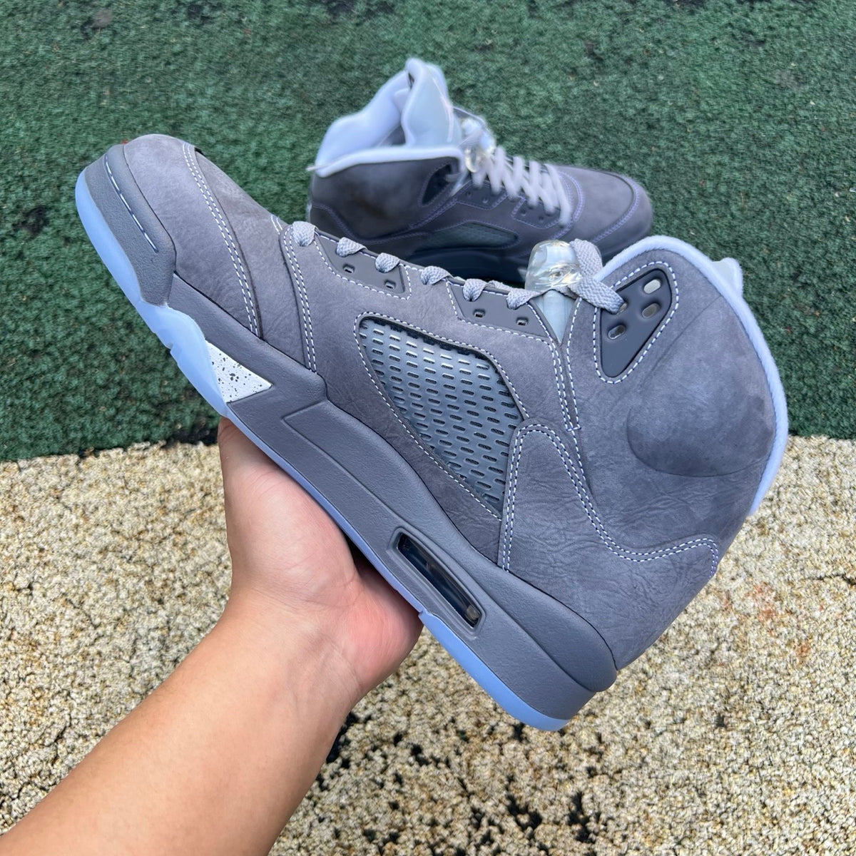 Nike Air Jordan 5 Retro Wolf Grey sneakers with grey suede and white accents, shown from a side angle.