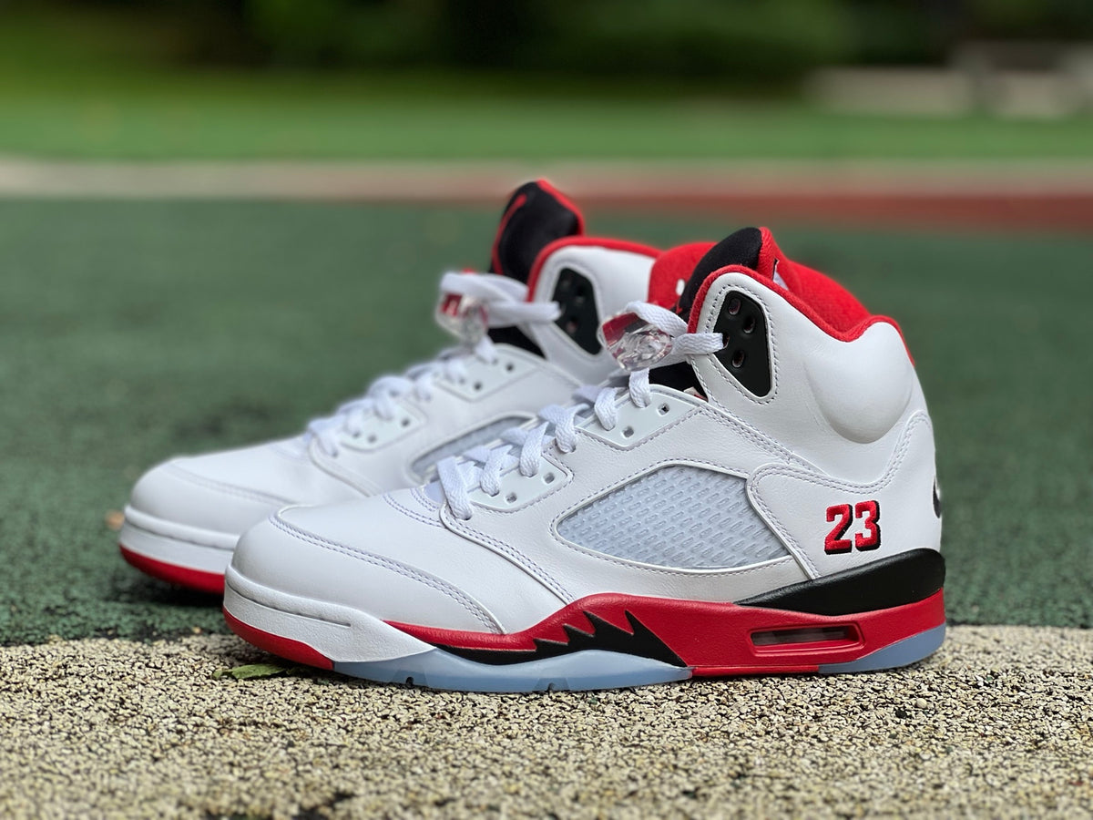Nike Air Jordan 5 Retro Fire Red and Black sneakers with a prominent tongue, detailed close-up showing design and materials