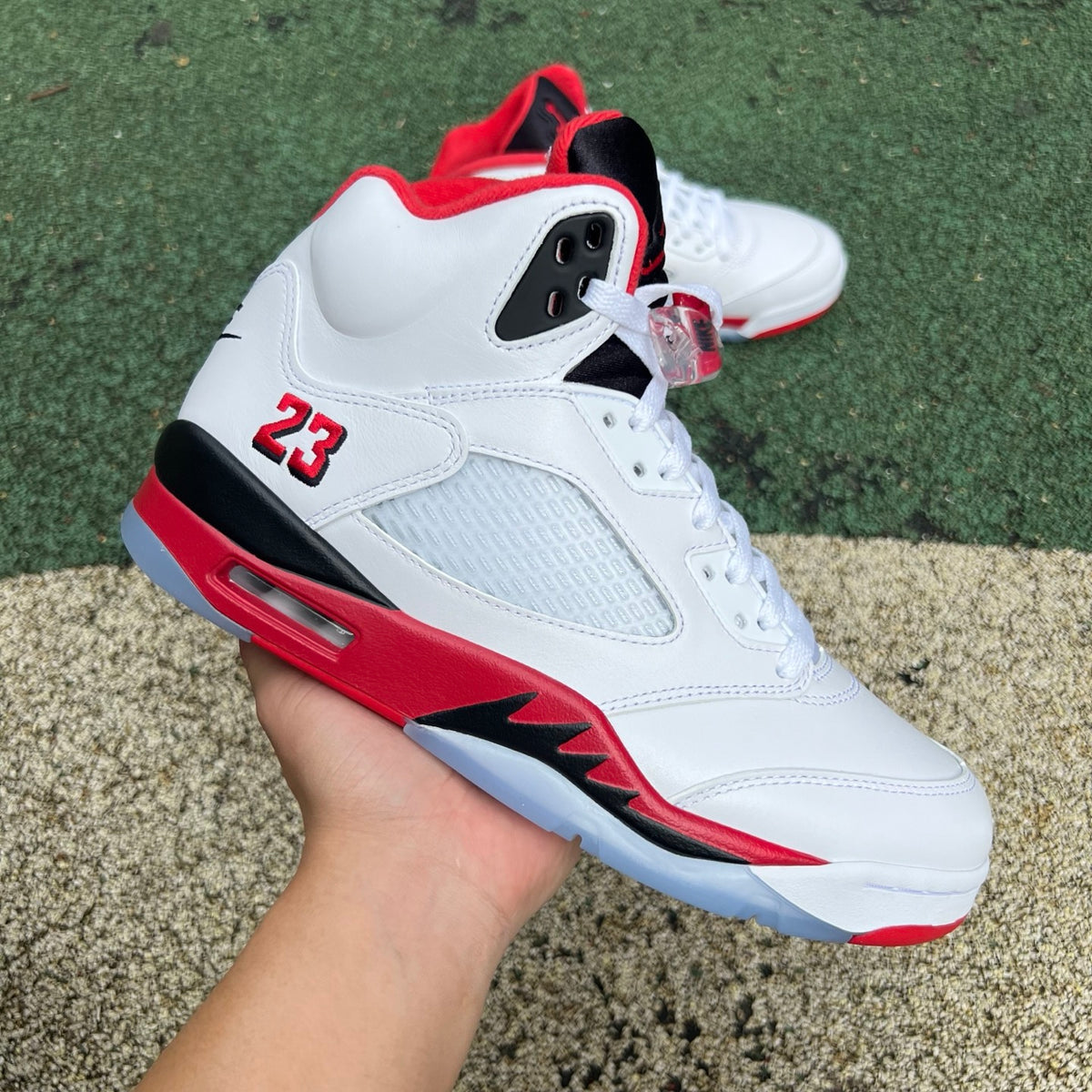 Nike Air Jordan 5 Retro Fire Red and Black sneakers with a prominent tongue, detailed view of the iconic design.