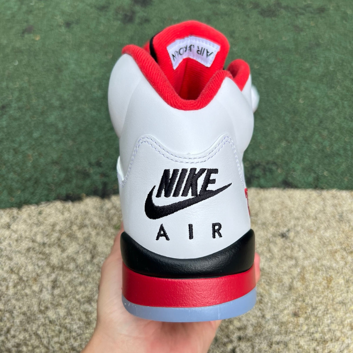 Nike Air Jordan 5 Retro Fire Red and Black sneakers with visible tongue and design details, high-quality image.