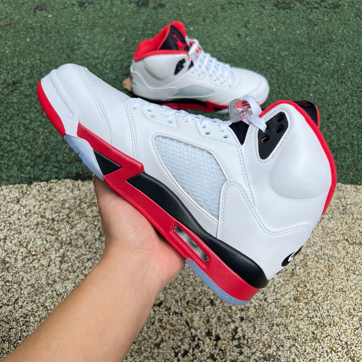 Nike Air Jordan 5 Retro Fire Red black tongue sneaker in a close-up view, showcasing the iconic design and color details.