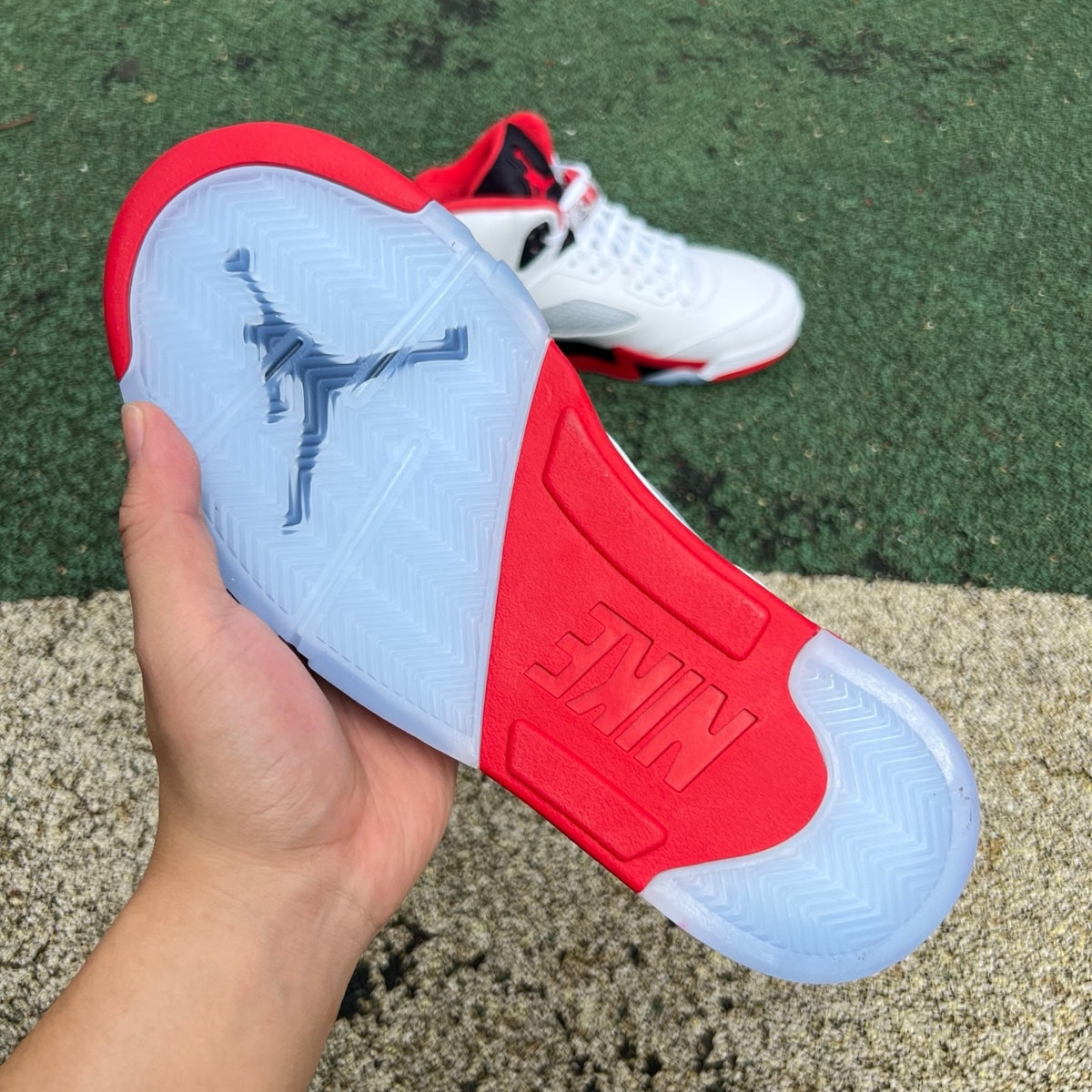 Nike Air Jordan 5 Retro Fire Red black tongue sneakers in close-up view showing the iconic design and color scheme.