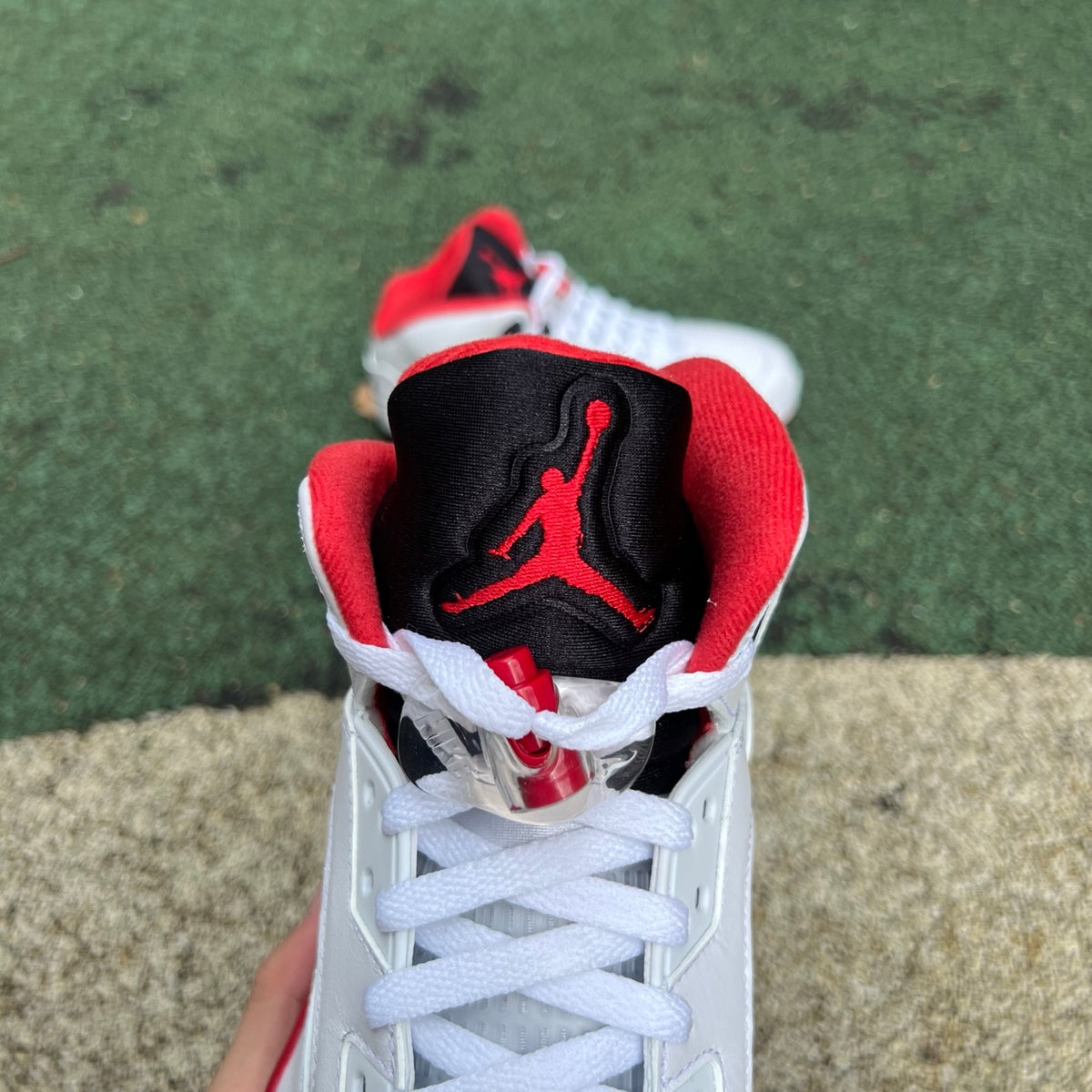 Nike Air Jordan 5 Retro Fire Red and black sneakers with a prominent tongue, high-quality image showing detailed design.