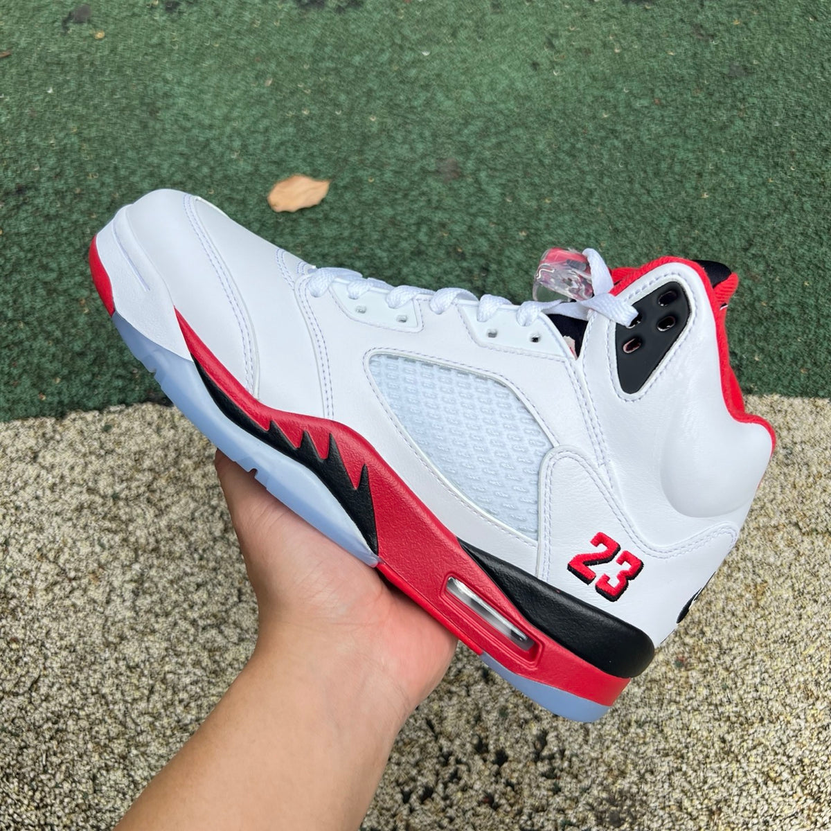 Nike Air Jordan 5 Retro Fire Red and Black sneakers with a prominent tongue, high-quality image showing front view and design details.