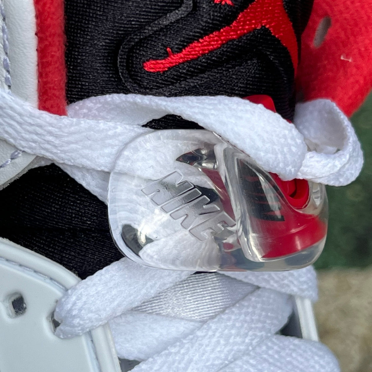 Nike Air Jordan 5 Retro Fire Red black tongue sneakers, featuring a classic design with red, black, and white accents.