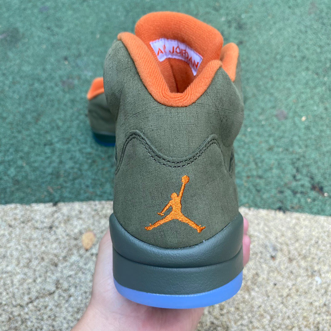 Nike Air Jordan 5 Retro Olive sneakers in a close-up view, showcasing the olive green and black design details.