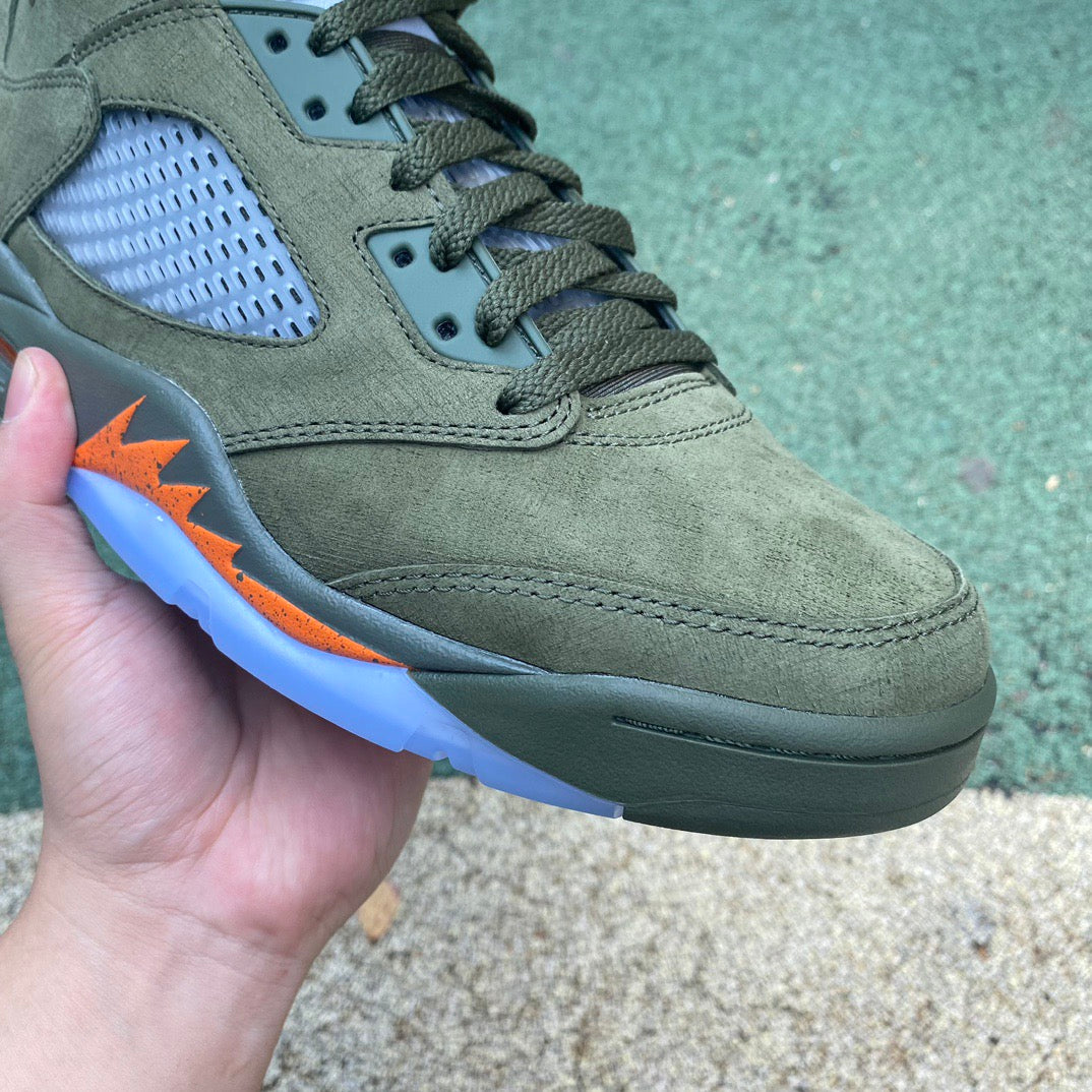 Nike Air Jordan 5 Retro Olive sneakers in a close-up image showcasing the olive green and black design details.