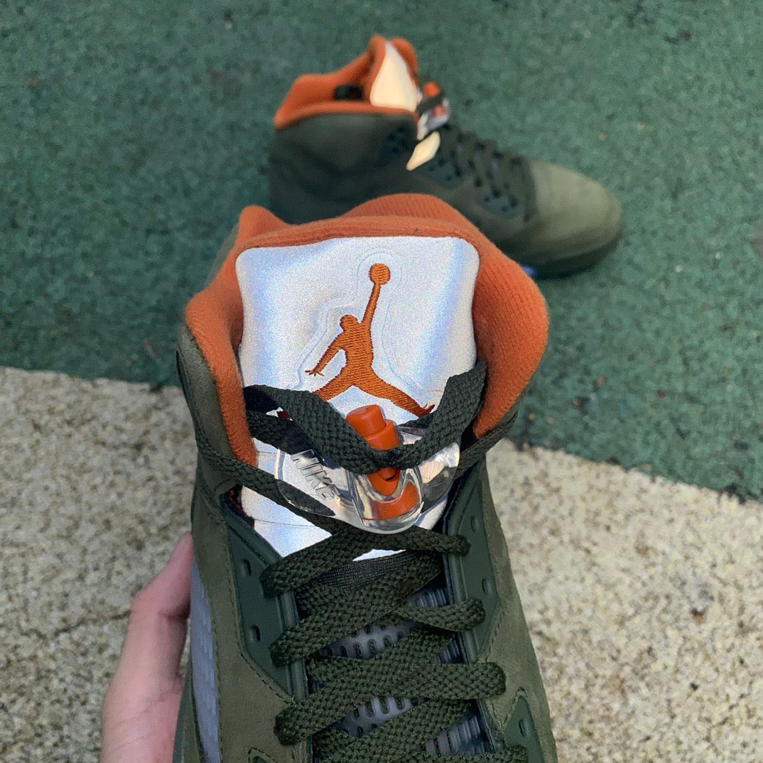 Nike Air Jordan 5 Retro Olive sneakers in a close-up view, showcasing the olive green and black design details.