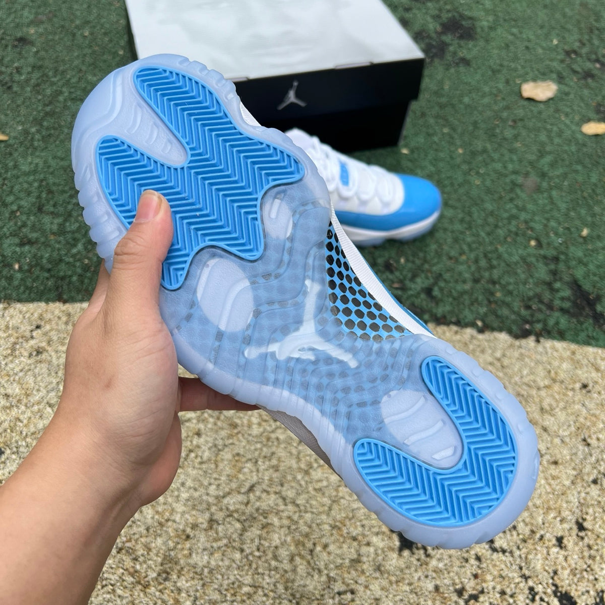 Nike Air Jordan 11 Retro Low University Blue sneakers, featuring blue and white colorway, sleek design, and iconic Jordan branding.
