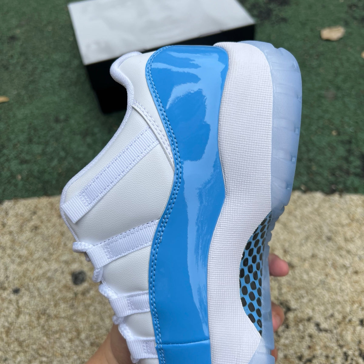 Nike Air Jordan 11 Retro Low University Blue sneaker featuring a blue and white design with patent leather detailing.