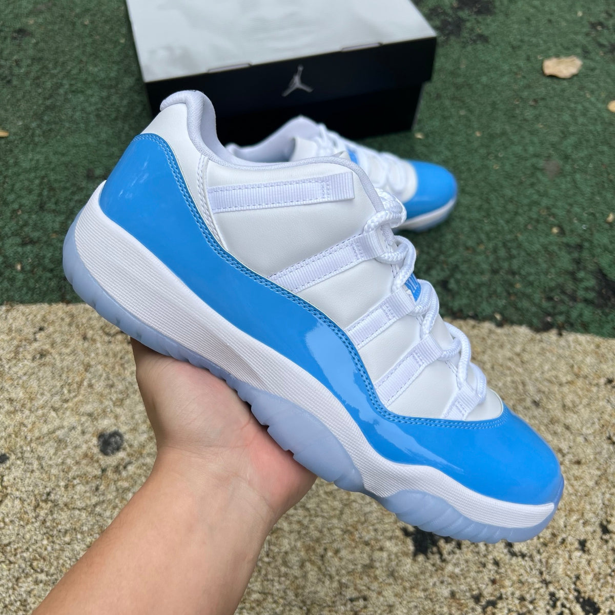 Nike Air Jordan 11 Retro Low University Blue sneakers, featuring blue and white design and signature Jordan branding.