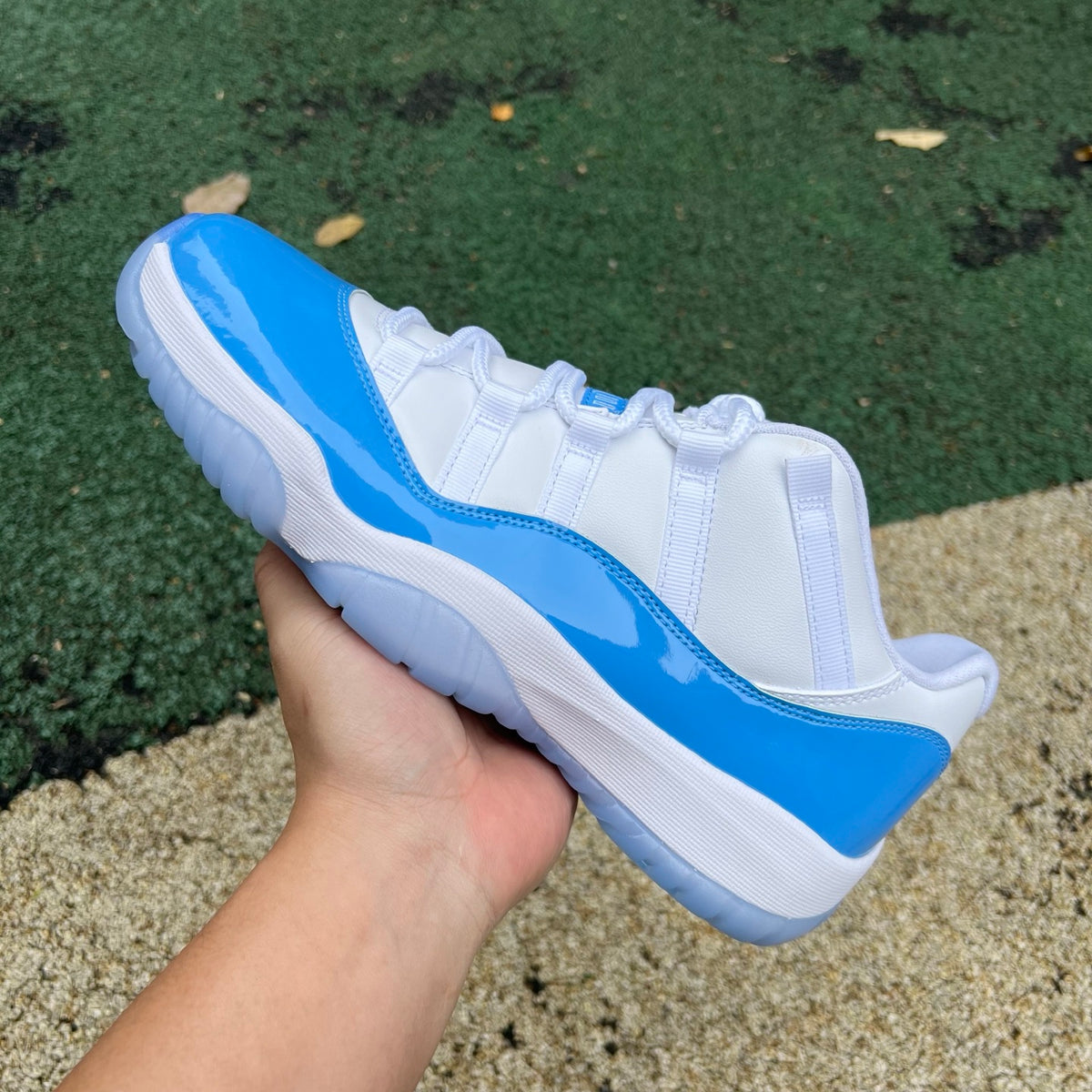 Nike Air Jordan 11 Retro Low University Blue sneakers in white and blue with sleek design and signature Jordan branding