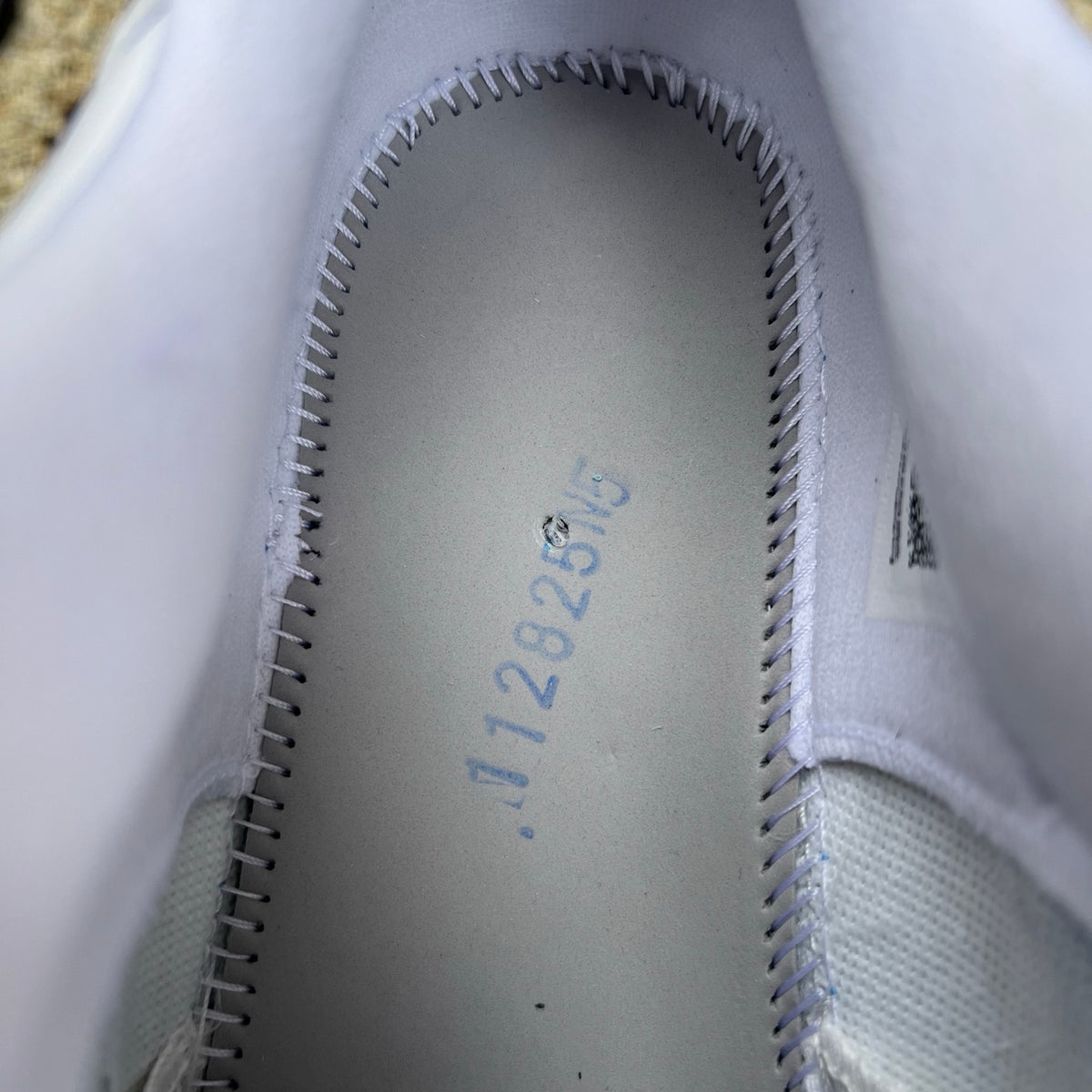 Nike Air Jordan 11 Retro Low University Blue sneakers in white and blue leather with patent leather accents, close-up view
