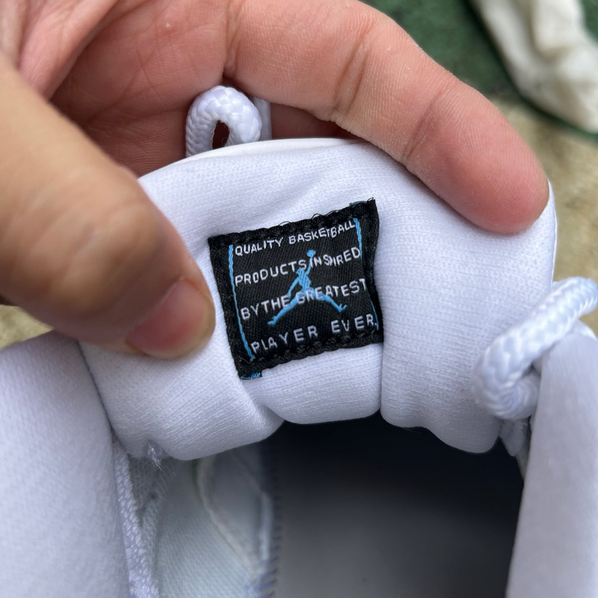 Nike Air Jordan 11 Retro Low University Blue sneaker, featuring blue patent leather and white accents, on a clean background.