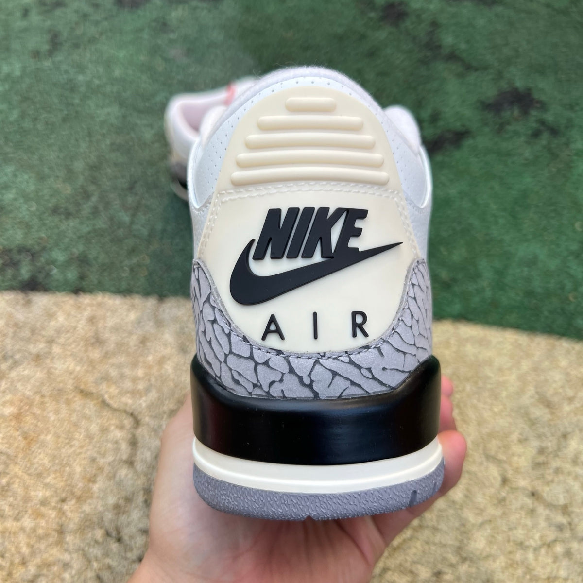 Nike Air Jordan 3 Retro White Cement Reimagined sneakers in GS size, featuring white leather and signature cement gray accents.