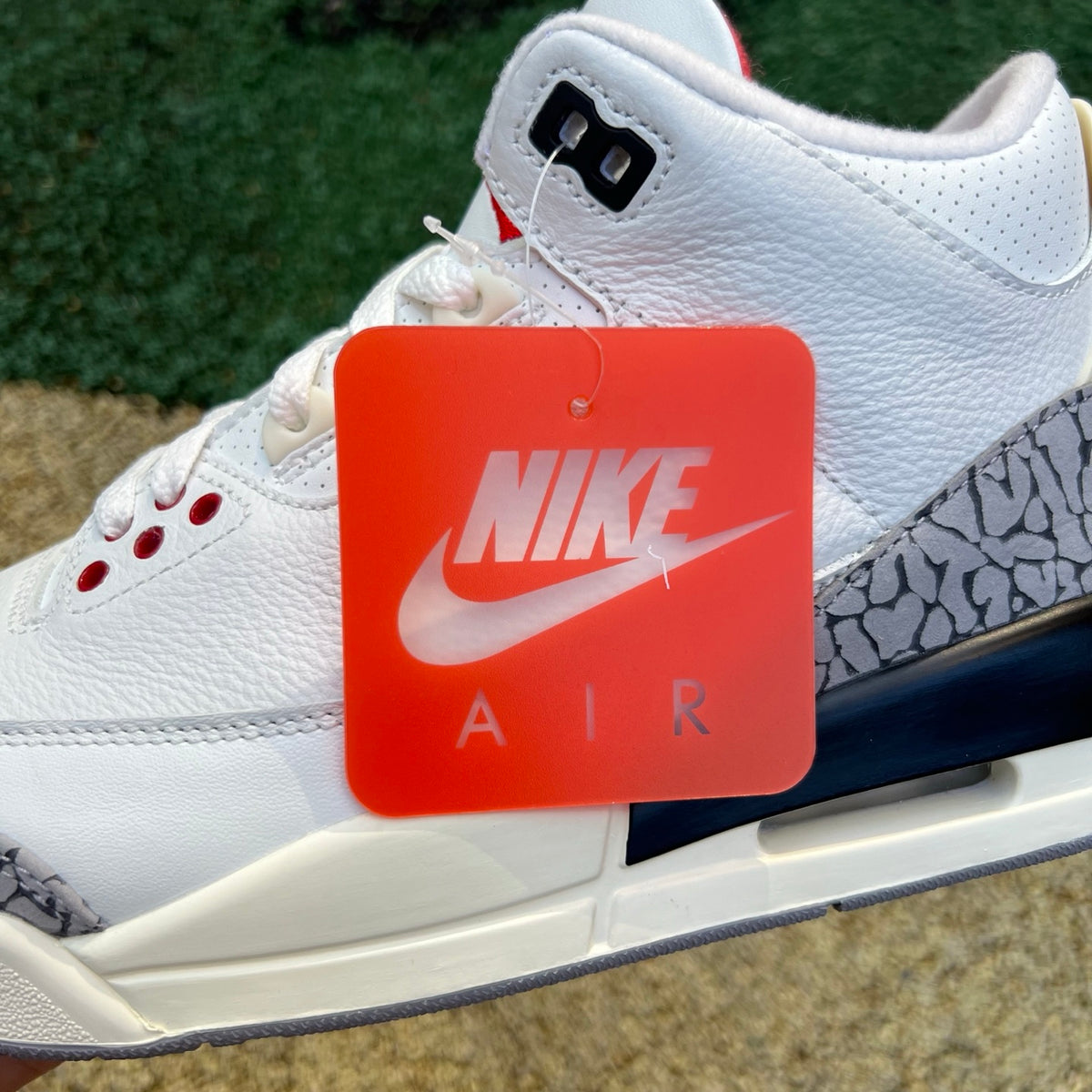 Nike Air Jordan 3 Retro White Cement Reimagined (GS) sneakers with white leather and grey cement accents, front view.
