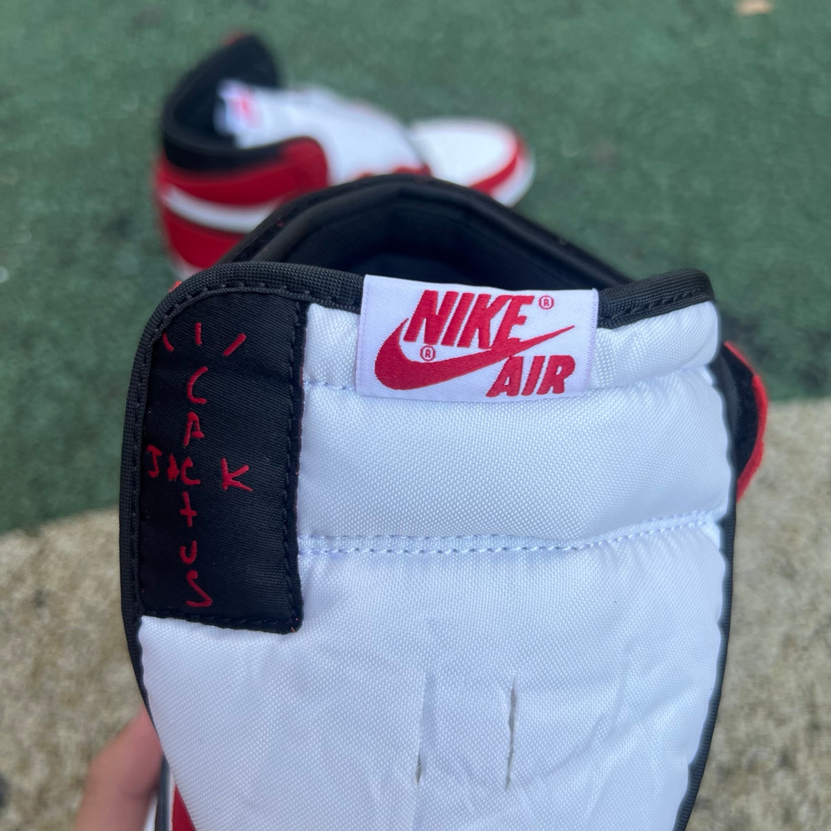 Nike Air Jordan 1 Retro High OG SP Fragment x Travis Scott sneakers in white and blue with Nike and Jordan branding.