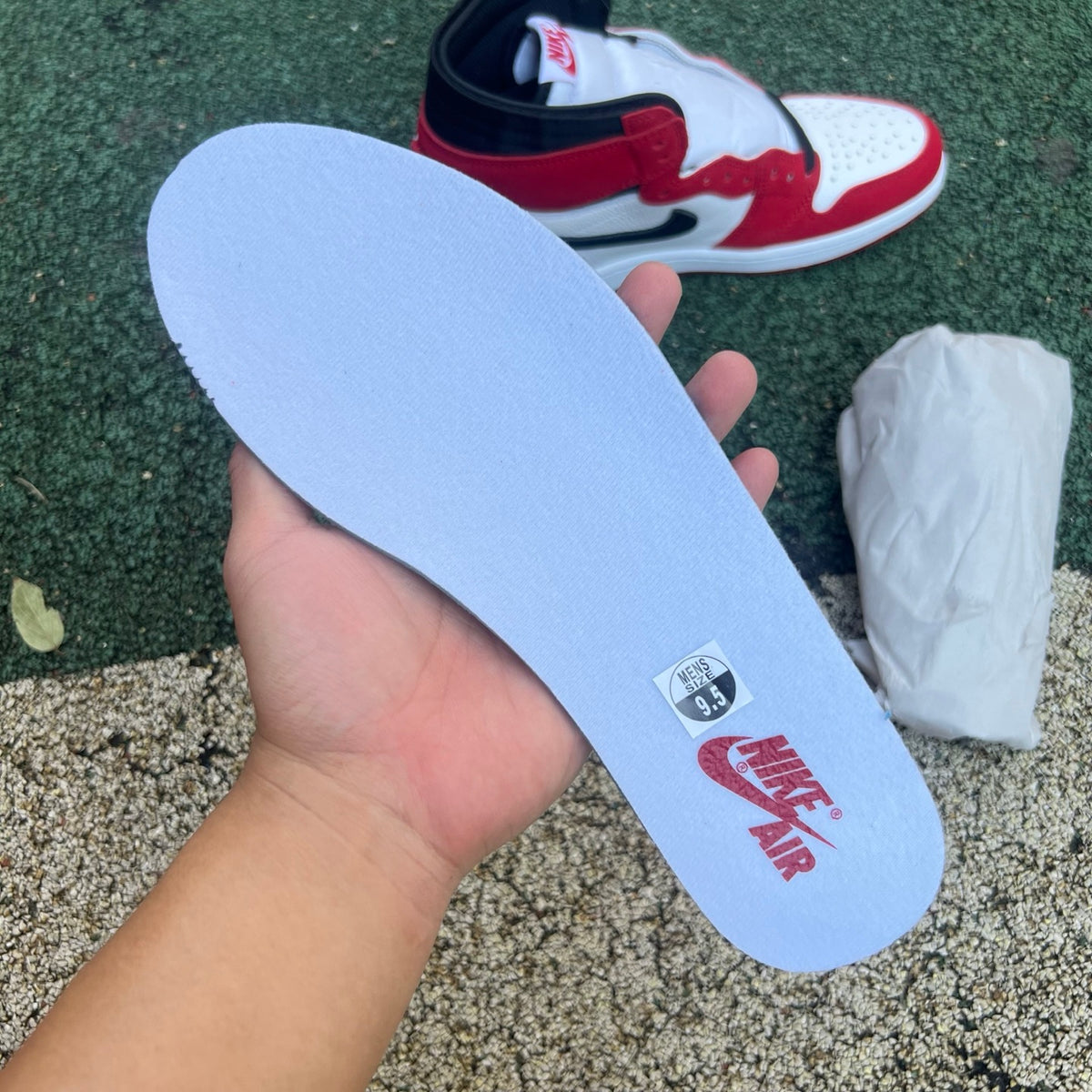 Nike Air Jordan 1 Retro High OG SP Fragment x Travis Scott sneaker in white and brown with Nike and Jordan branding.