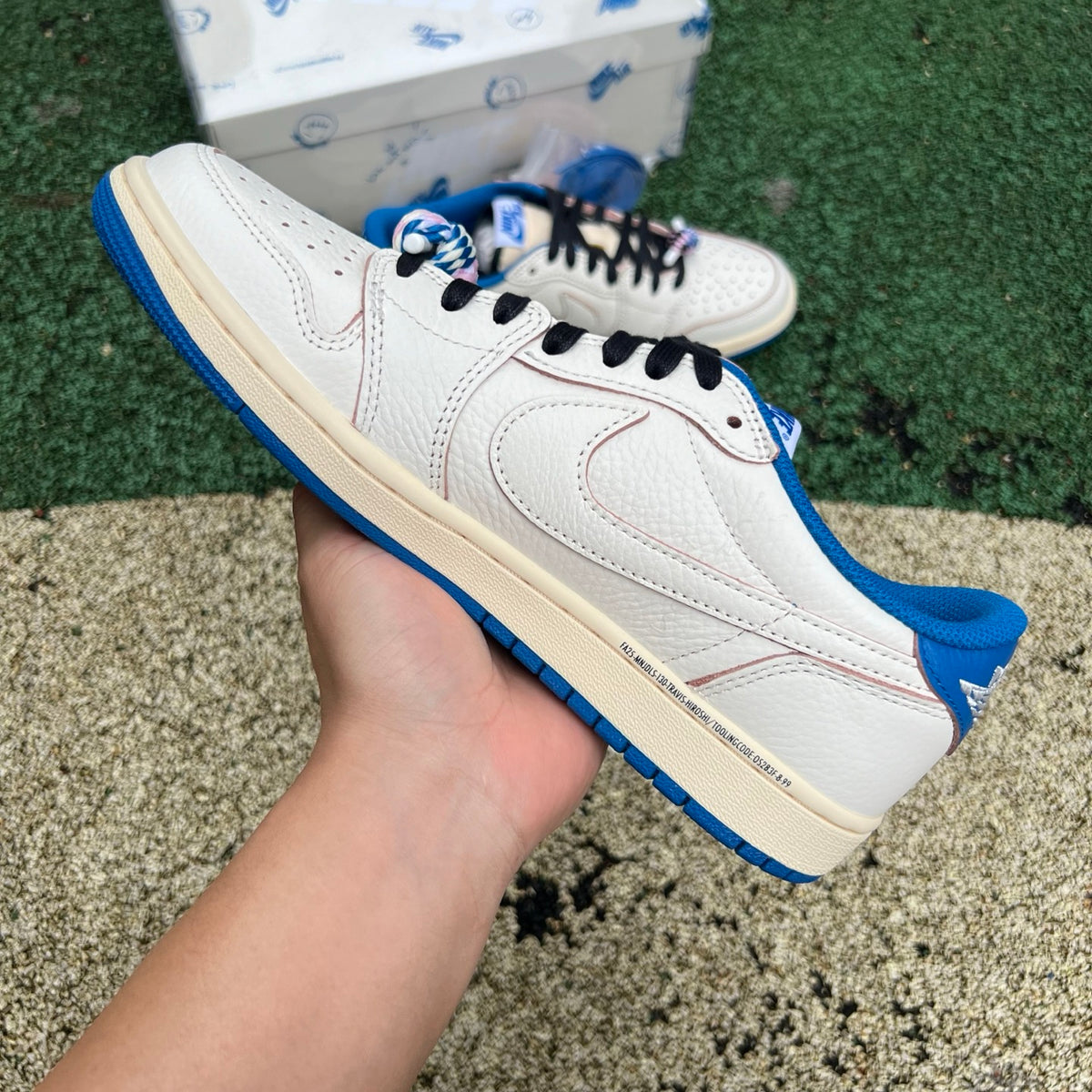 Nike Air Jordan 1 Retro Low OG SP Fragment x Travis Scott sneakers in sail and military blue with Nike Jordan branding