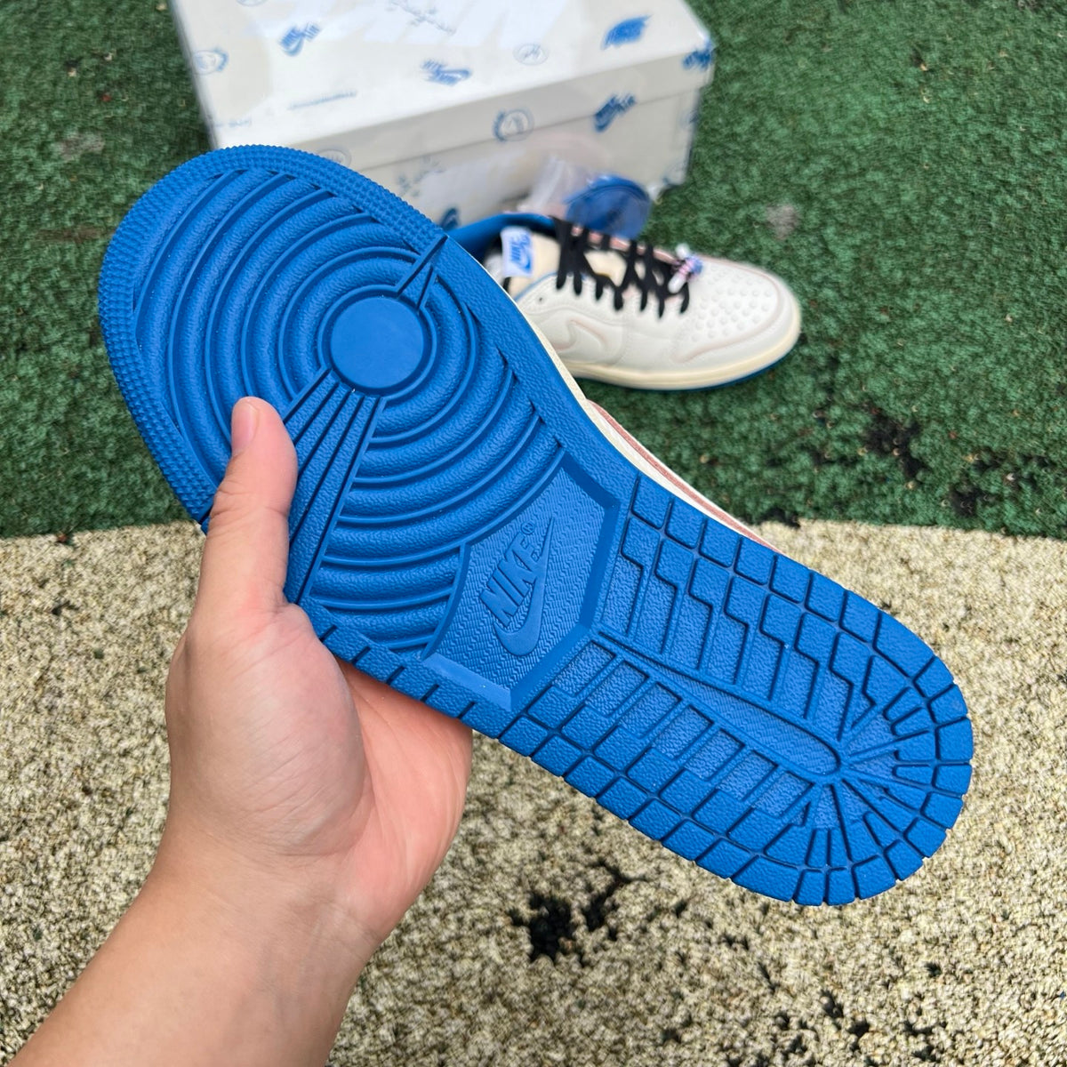 Nike Air Jordan 1 Retro Low OG SP Fragment x Travis Scott sneakers in Sail and Military Blue with Nike and Jordan branding.