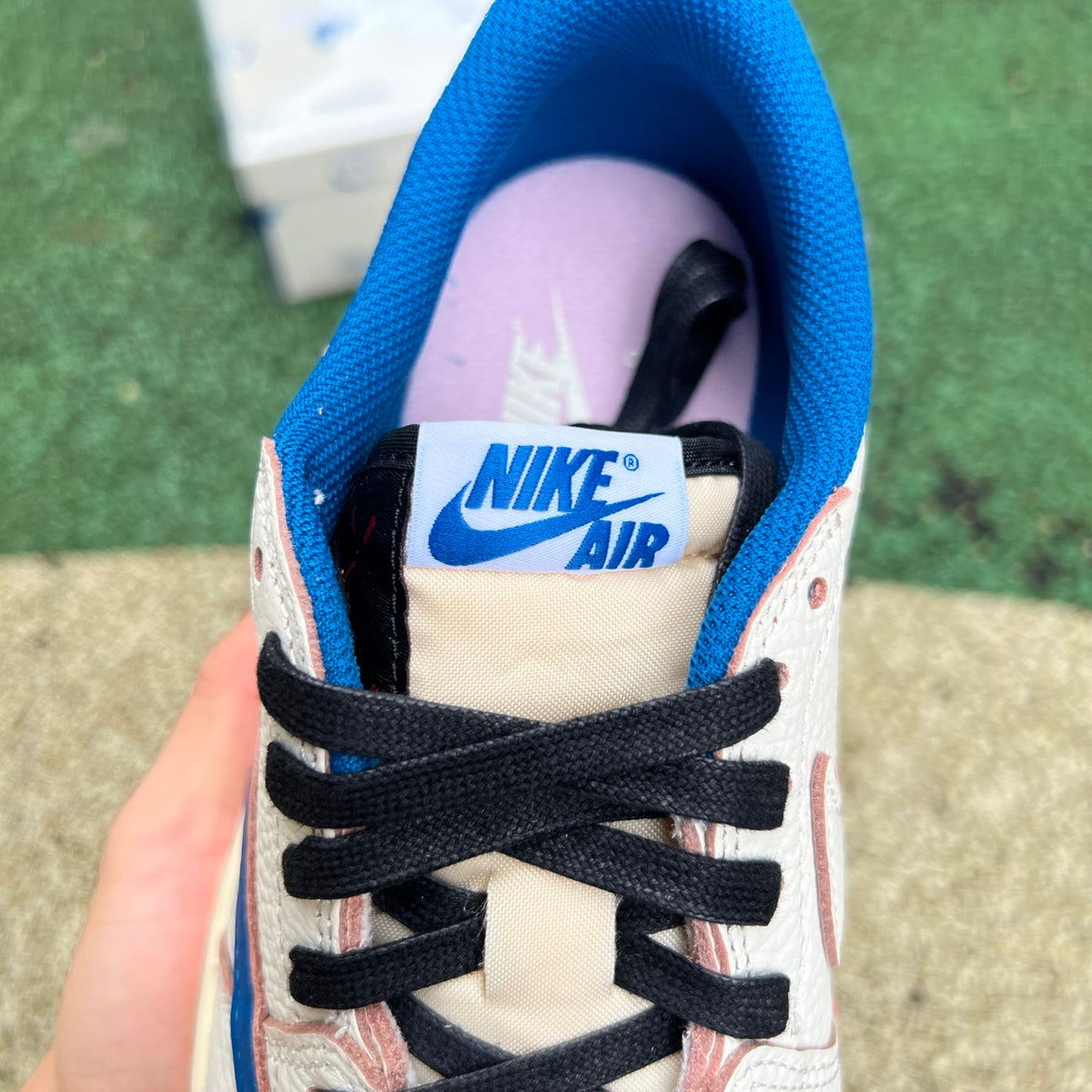 Nike Air Jordan 1 Retro Low OG SP Fragment x Travis Scott sneakers in Sail and Military Blue, showing the detailed side view.