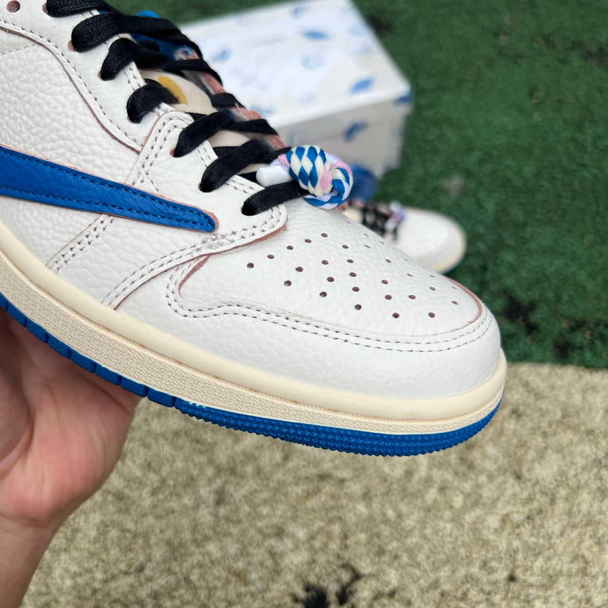 Nike Air Jordan 1 Retro Low OG SP Fragment x Travis Scott sneakers in Sail and Military Blue with branding details.
