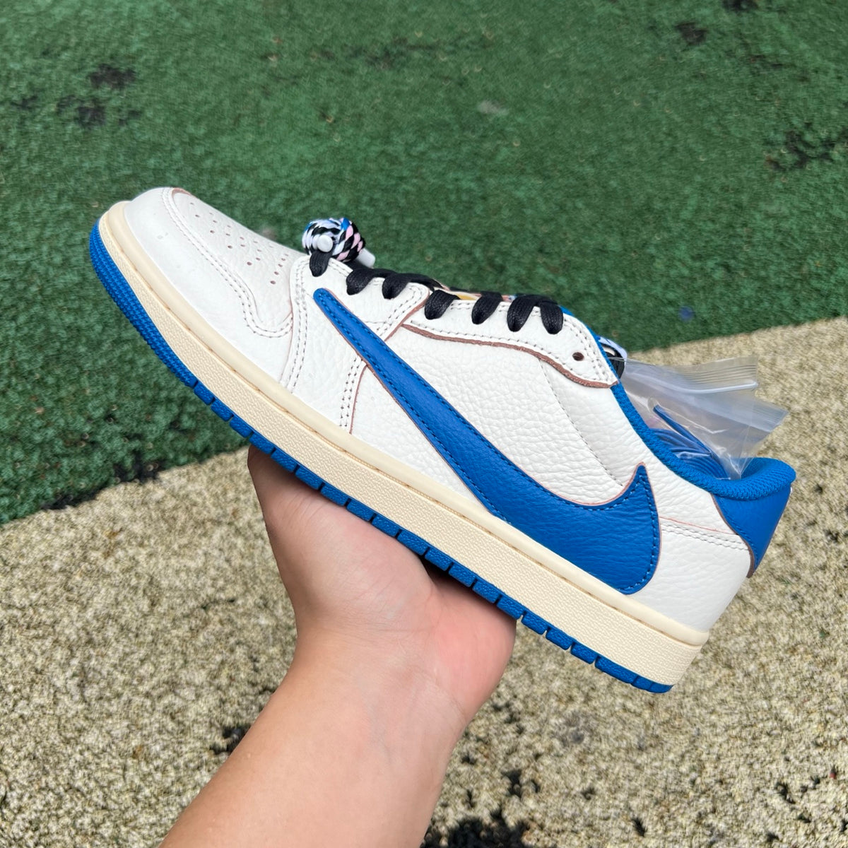 Nike Air Jordan 1 Retro Low OG SP Fragment x Travis Scott sneakers in Sail and Military Blue, featuring Nike x Jordan branding.