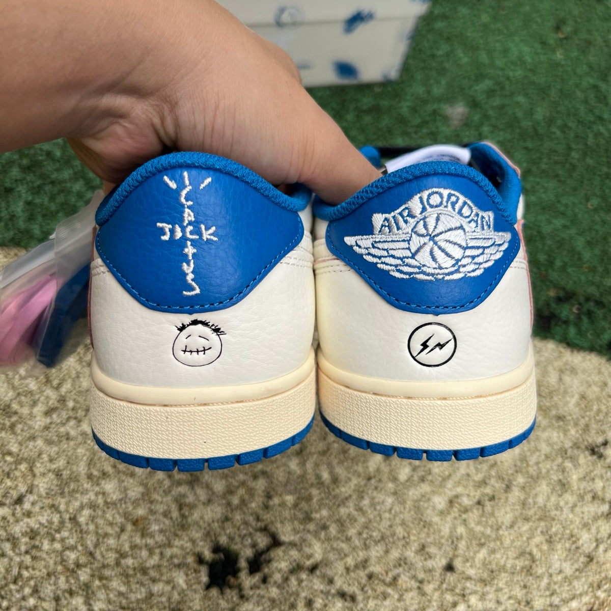Nike Air Jordan 1 Retro Low OG SP Fragment x Travis Scott sneakers in Sail and Military Blue, shown from a side angle.