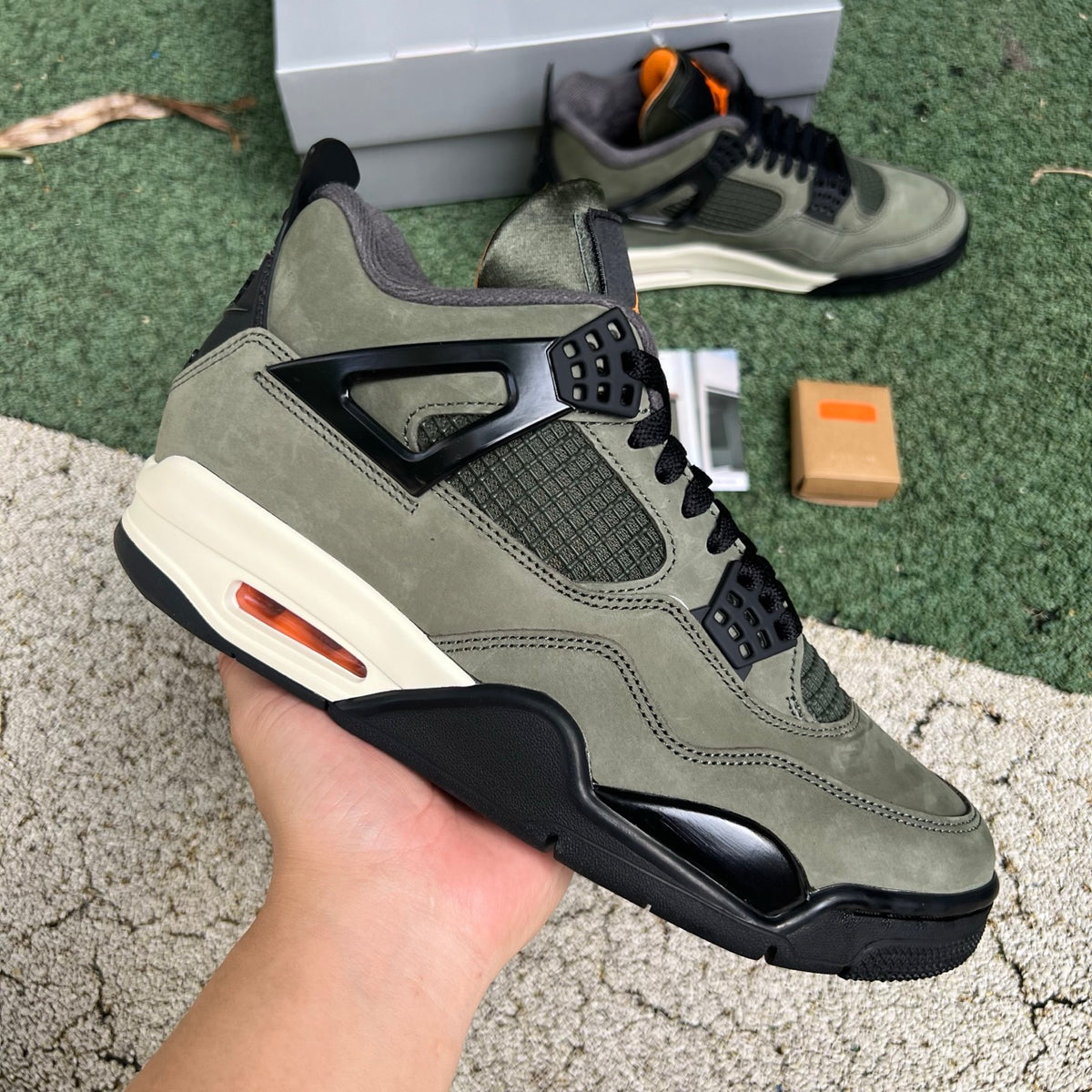 Nike Air Jordan 4 Retro OG SP Undefeated sneakers in black and white with distinctive design details, Nike x Jordan collaboration.