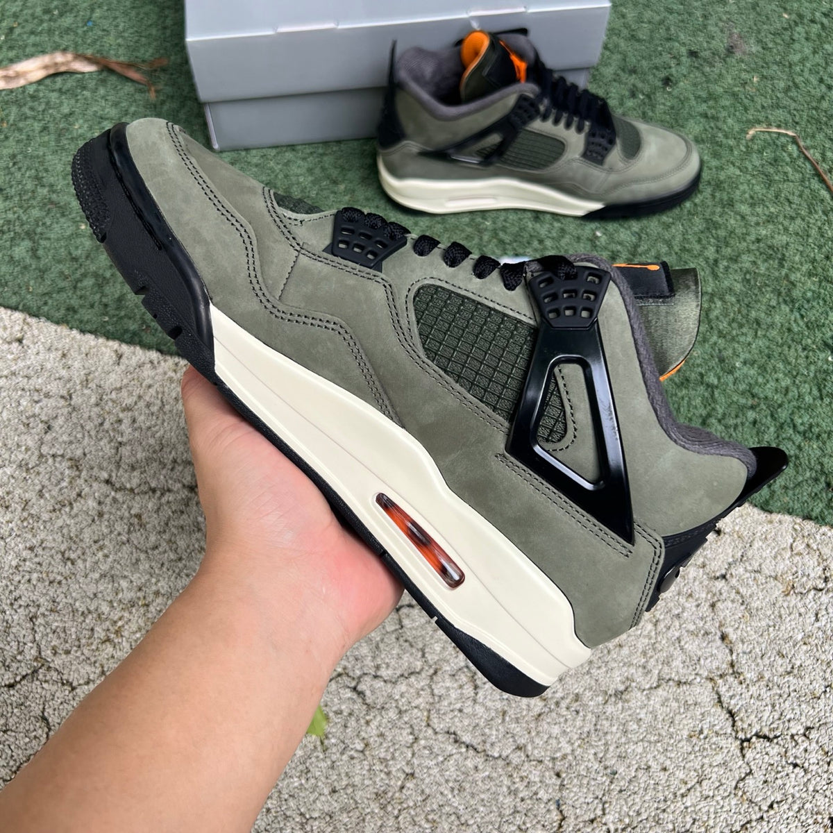 Nike Air Jordan 4 Retro OG SP Undefeated sneakers in black and white with signature design details and branding.