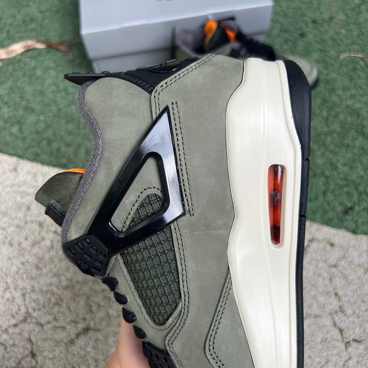 Nike Air Jordan 4 Retro OG SP Undefeated sneakers in white and black with red accents, featuring classic Jordan design details.