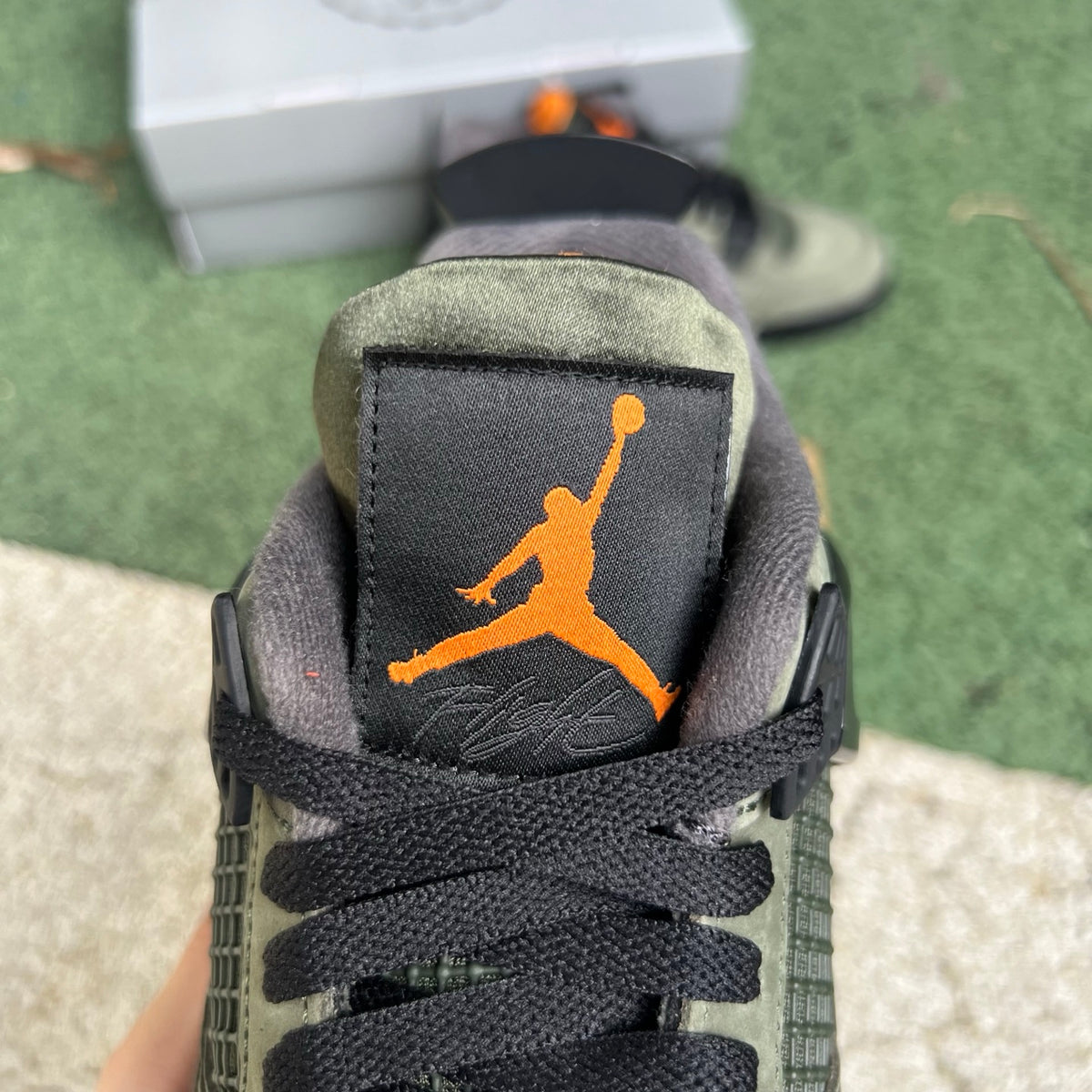 Nike Air Jordan 4 Retro OG SP Undefeated sneakers in black and white with signature design details and branding.