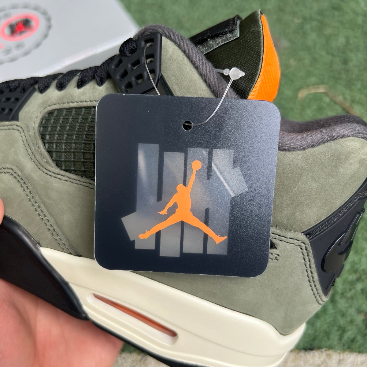 Nike Air Jordan 4 Retro OG SP Undefeated sneakers in black and white with distinctive design details and Nike x Jordan branding