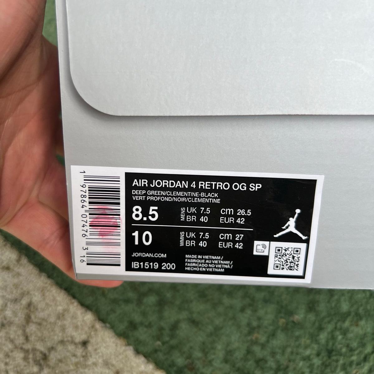 Nike Air Jordan 4 Retro OG SP Undefeated sneakers in black and white with signature design details, displayed on a plain background.