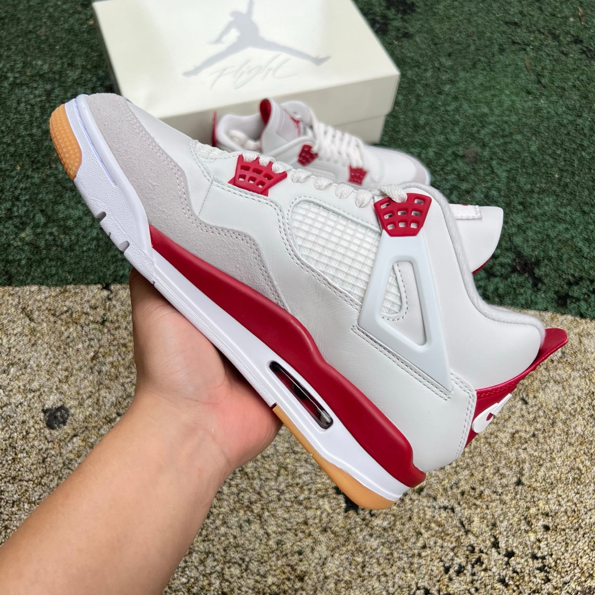 Nike Air Jordan 4 Retro SB Varsity Red sneakers with white and red colorway, featuring classic design details.
