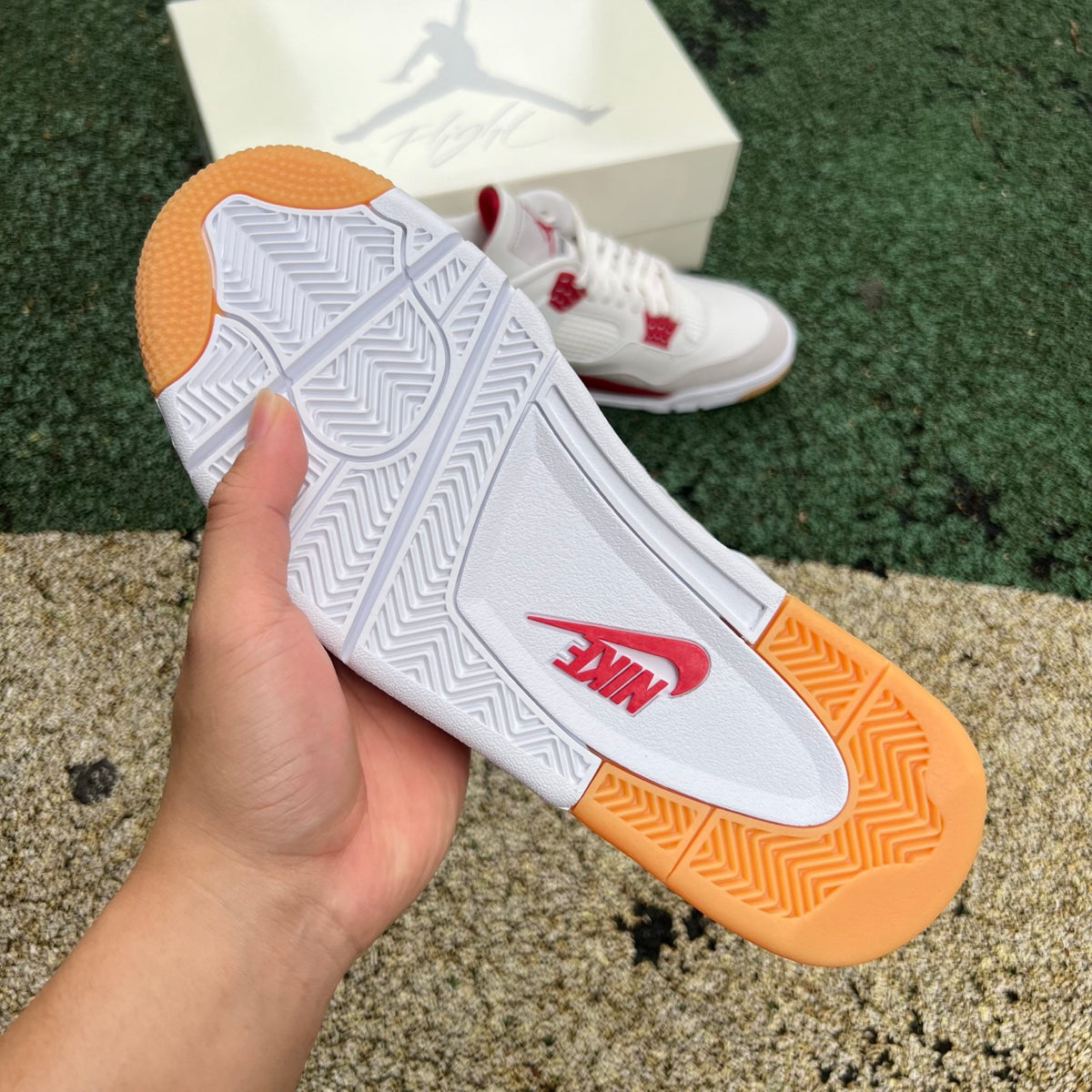 Nike Air Jordan 4 Retro SB Varsity Red sneakers with white accents and black rubber outsole, displayed on a white background.