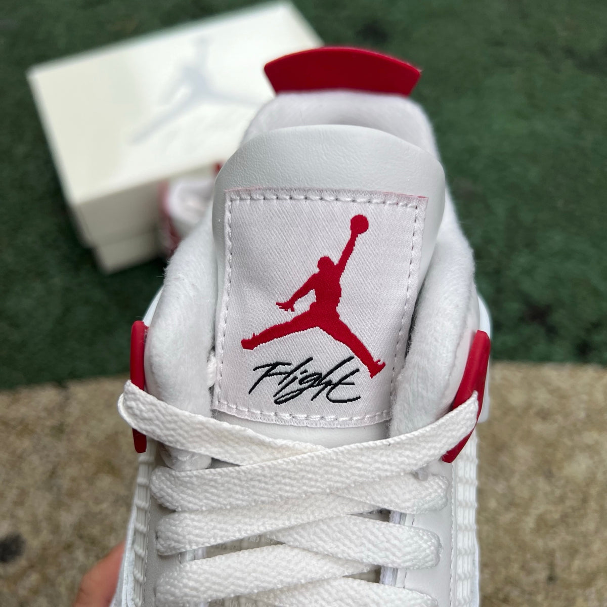 Nike Air Jordan 4 Retro SB Varsity Red sneakers showcasing red leather and black accents, featuring classic Jordan design details.