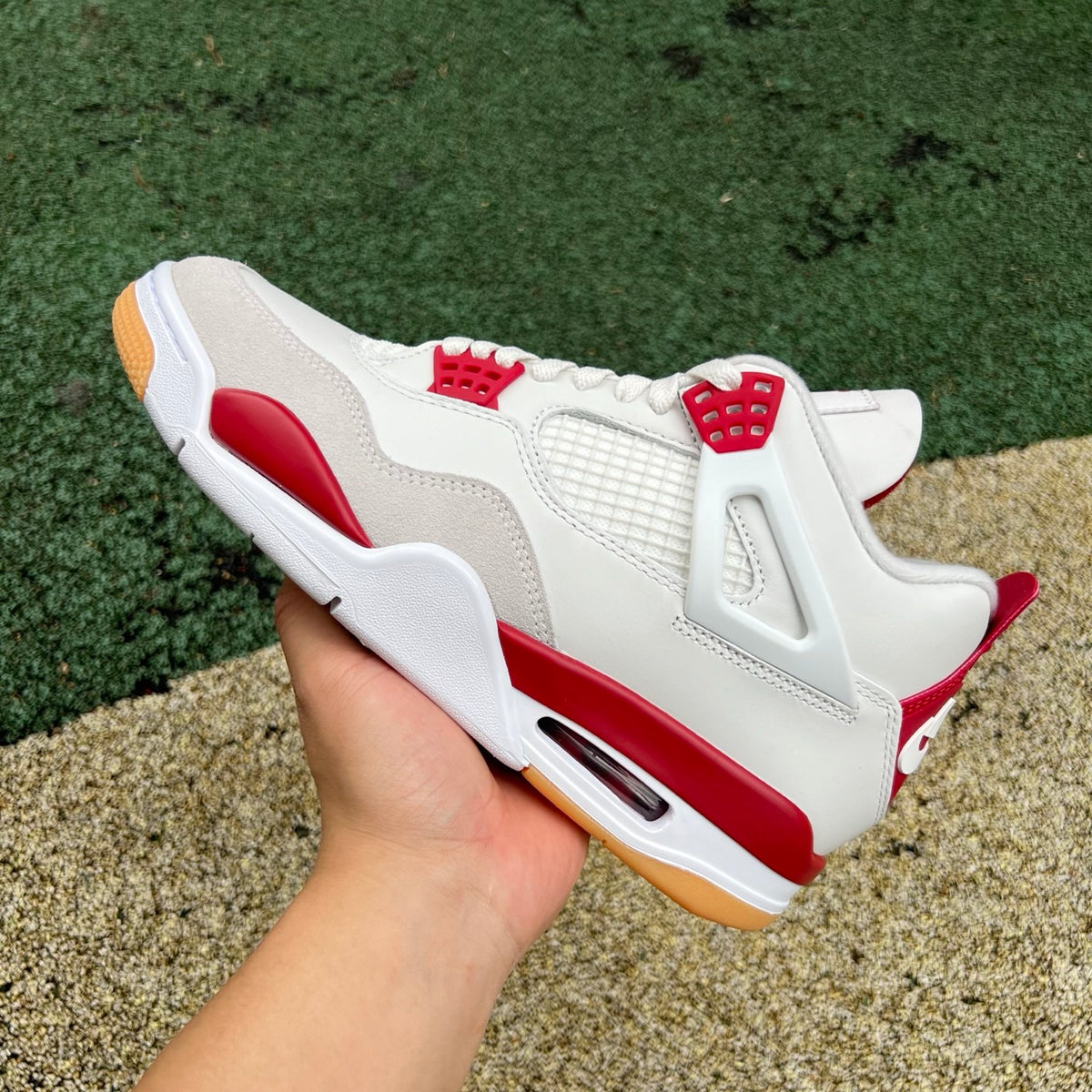 Nike Air Jordan 4 Retro SB Varsity Red sneakers, side view showcasing red leather upper and classic design details.