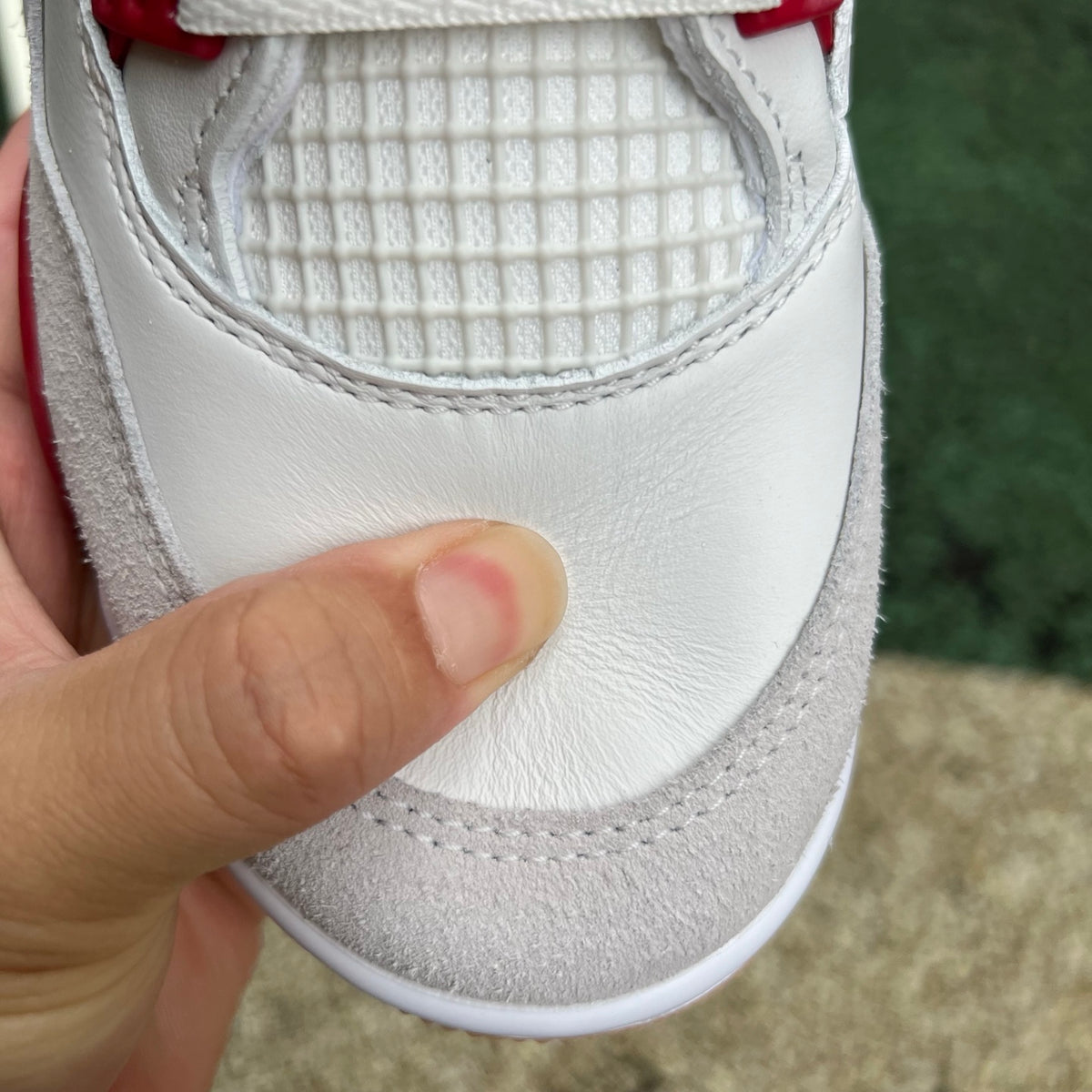 Nike Air Jordan 4 Retro SB Varsity Red sneakers with white and red color blocking, featuring classic design and Nike Jordan branding.