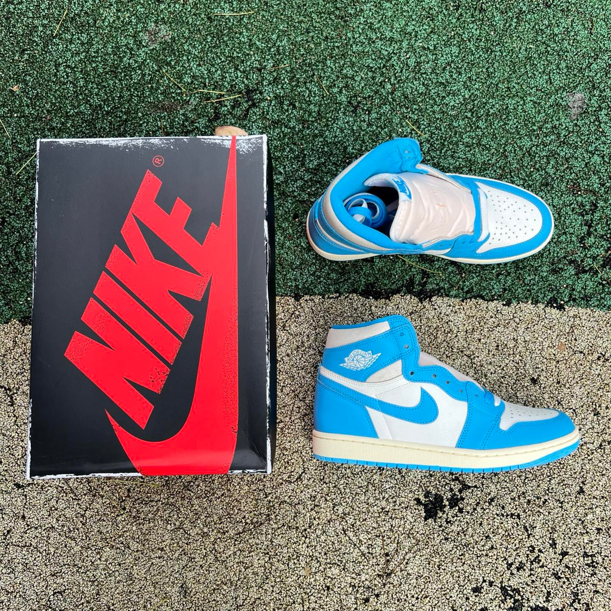 Nike Air Jordan 1 Retro High OG UNC Reimagined sneakers in white and blue with black accents, featuring a classic high-top design.