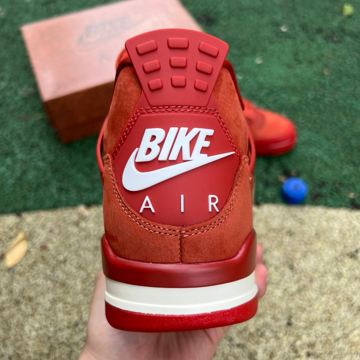 Nike Air Jordan 4 Retro OG SP Nigel Sylvester Brick by Brick sneakers in black and red, featuring distinctive design details.